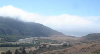 Landscape - mountains on each side of a river flowing into the ocean