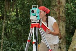 Student using total mapping station in Belize