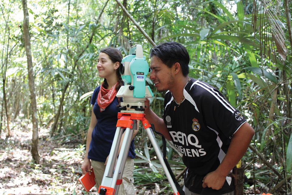 People looking through a mapping station on a tripod