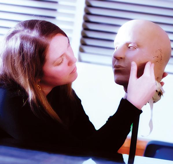 Alisha Gaskins skulpting a face with clay