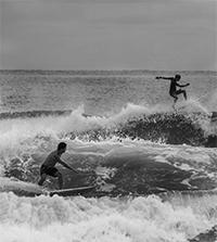 Two people surfing