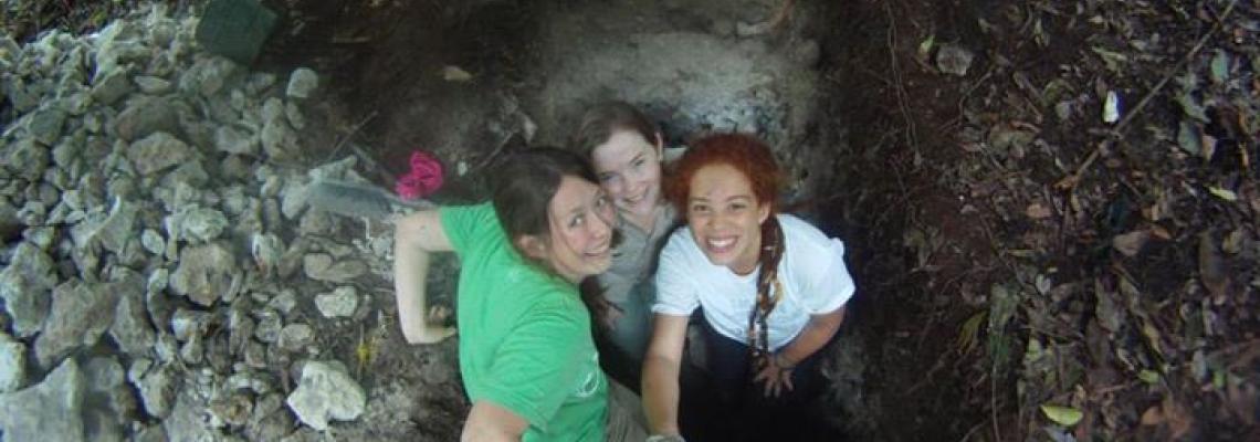 Three students exploring a cave
